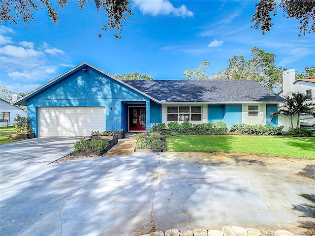 single story home featuring a garage and a front yard