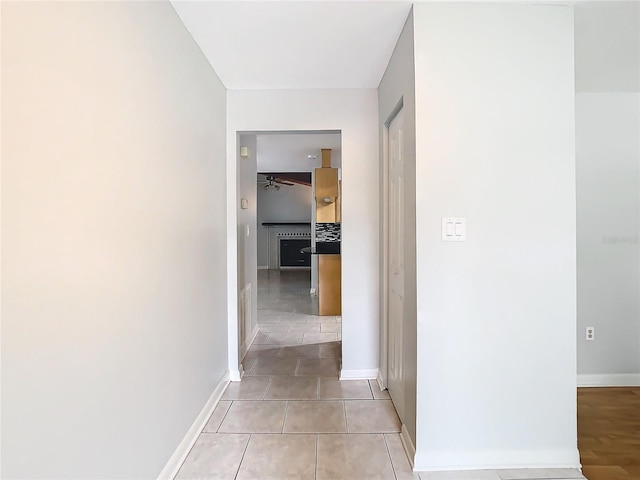 hall with light tile patterned floors