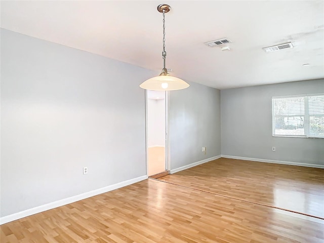 unfurnished room featuring hardwood / wood-style floors