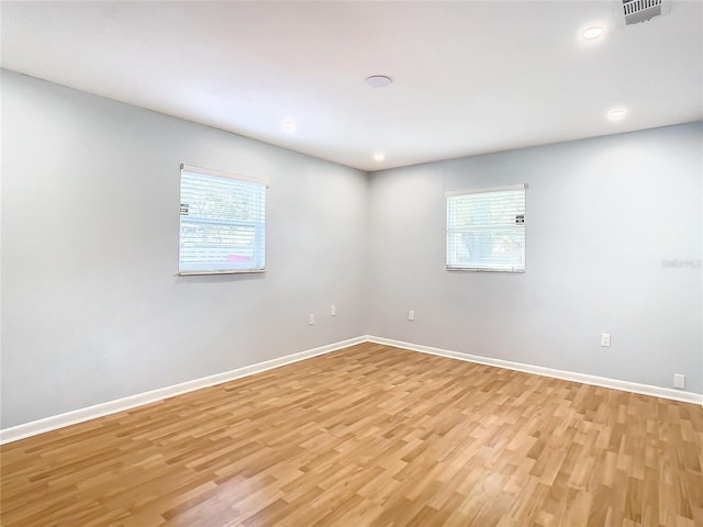 spare room with light hardwood / wood-style flooring