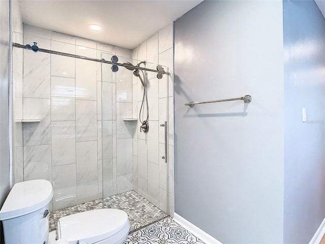 bathroom with tile patterned floors, toilet, and a shower with shower door