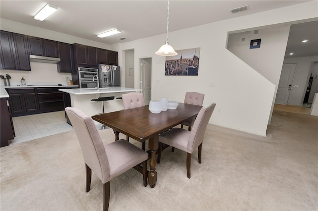 dining area with light colored carpet