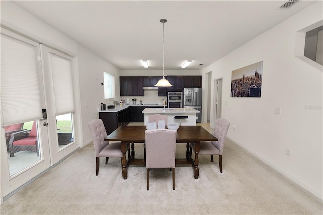 carpeted dining area with sink