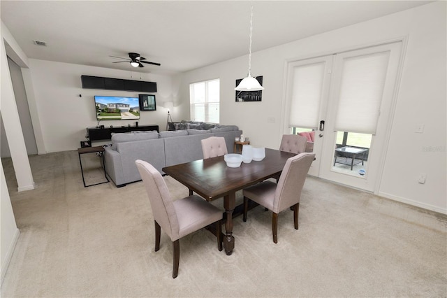 dining room featuring light colored carpet and ceiling fan