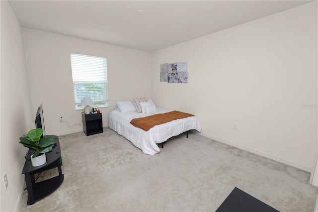 bedroom featuring light colored carpet