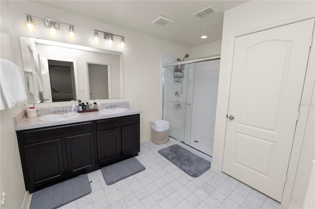 bathroom featuring vanity and an enclosed shower