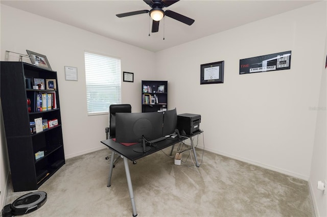 carpeted office featuring ceiling fan