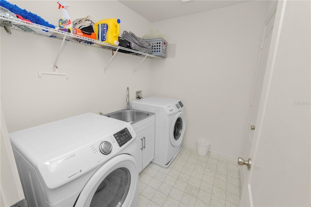 laundry room with separate washer and dryer, sink, and cabinets