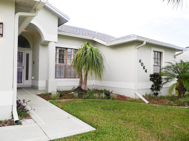 view of side of property with a lawn