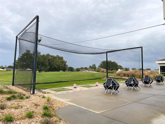 view of property's community with a patio area, a yard, and an outdoor fire pit