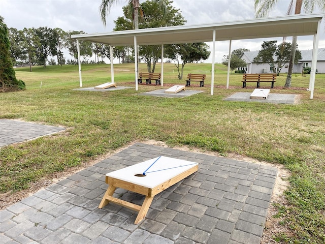 view of community with a lawn and a patio