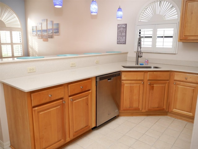 kitchen with dishwasher, decorative light fixtures, and sink