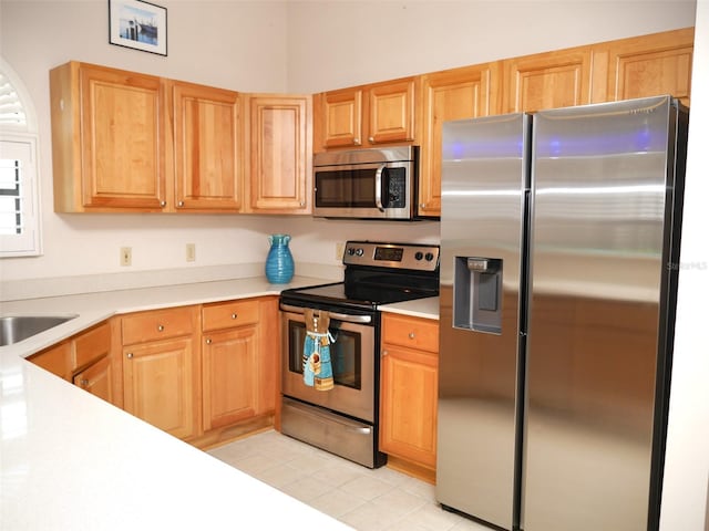 kitchen with light tile patterned floors and appliances with stainless steel finishes