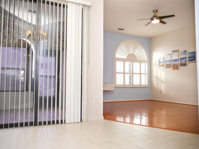 unfurnished room with ceiling fan and light hardwood / wood-style flooring