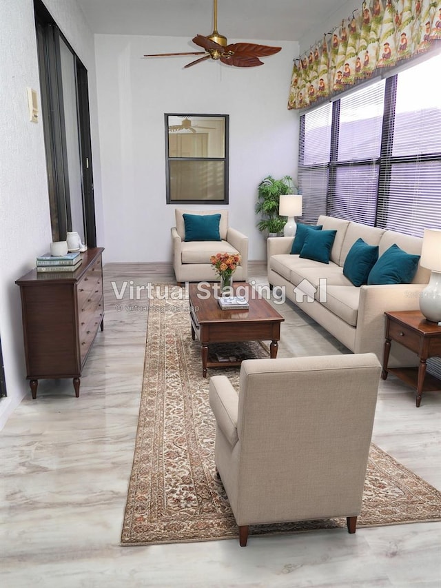 living room featuring ceiling fan and light hardwood / wood-style flooring