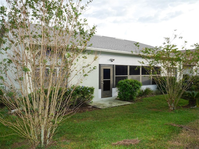 rear view of property with a yard