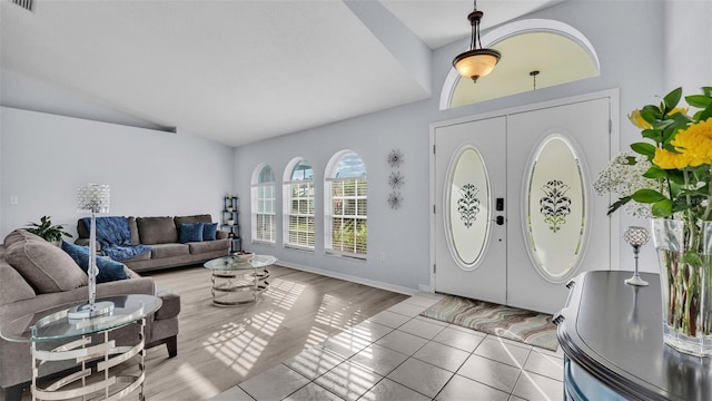 entryway with hardwood / wood-style flooring, vaulted ceiling, and french doors