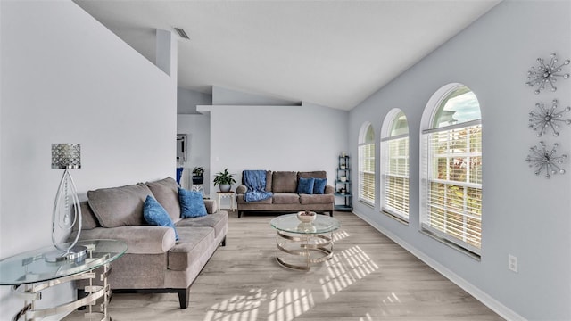 living room featuring light hardwood / wood-style flooring and lofted ceiling