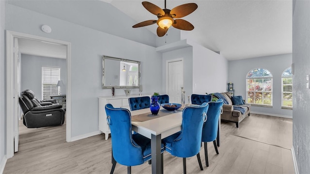 dining room with ceiling fan, light hardwood / wood-style flooring, and lofted ceiling