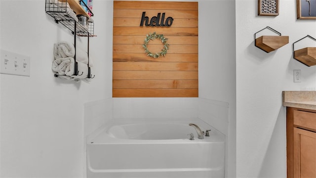 bathroom featuring vanity and a tub