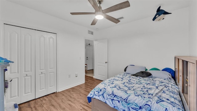 bedroom with wood-type flooring, a closet, and ceiling fan