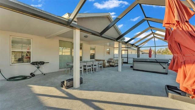 view of patio with a lanai and a hot tub