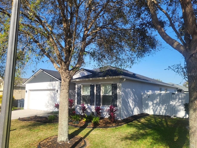 ranch-style house featuring stucco siding, driveway, fence, an attached garage, and a front yard