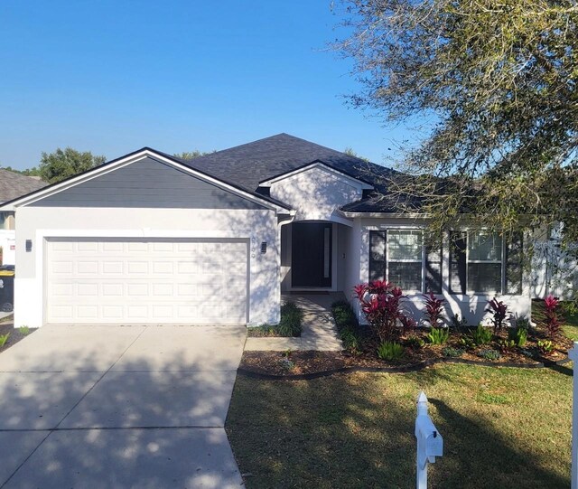 single story home with stucco siding, driveway, a shingled roof, and a garage