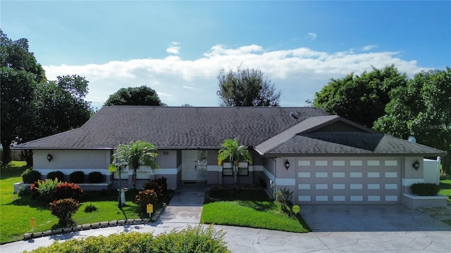 view of front of property featuring a front yard and a garage