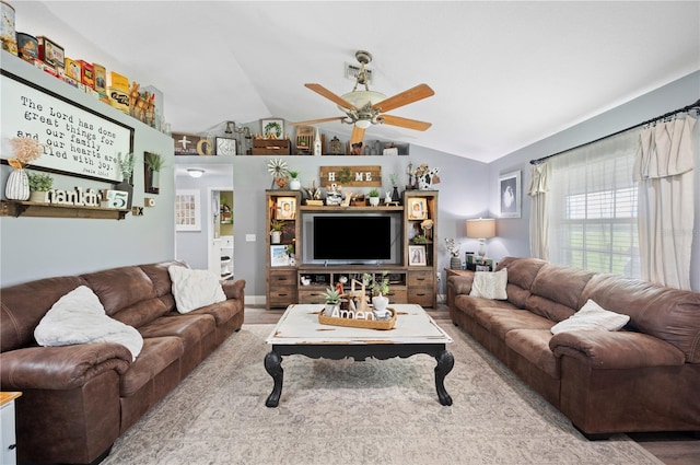 living room featuring wood-type flooring, lofted ceiling, and ceiling fan