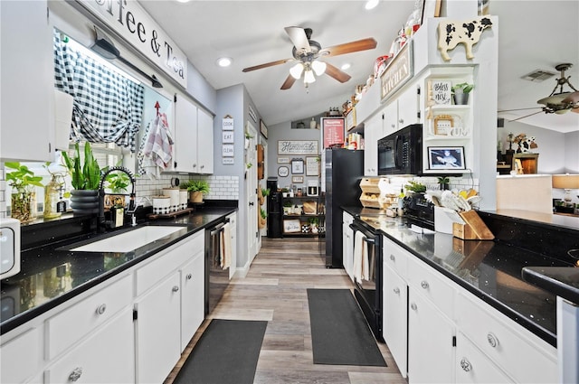 kitchen with white cabinetry, sink, and black appliances