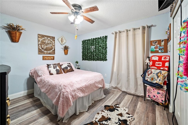 bedroom featuring hardwood / wood-style floors, a textured ceiling, ceiling fan, and a closet