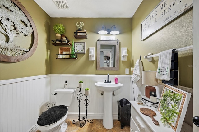 bathroom featuring tile patterned flooring and toilet