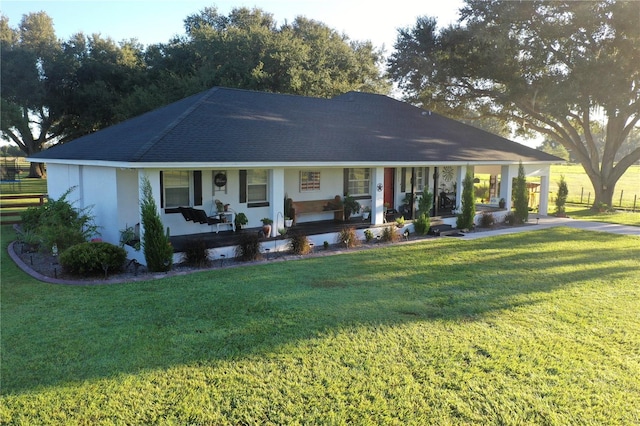 view of front of home with a front yard and covered porch