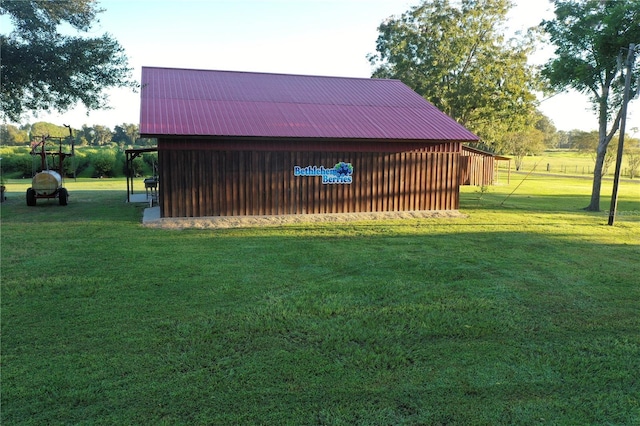 view of outbuilding featuring a yard