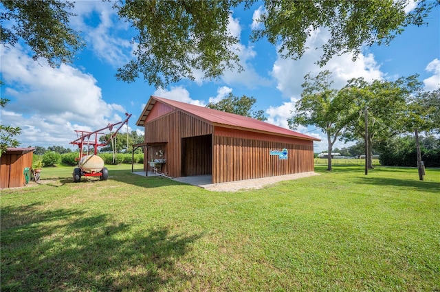 view of outbuilding featuring a lawn