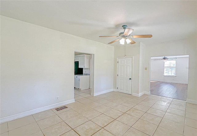 spare room featuring ceiling fan and light tile patterned floors