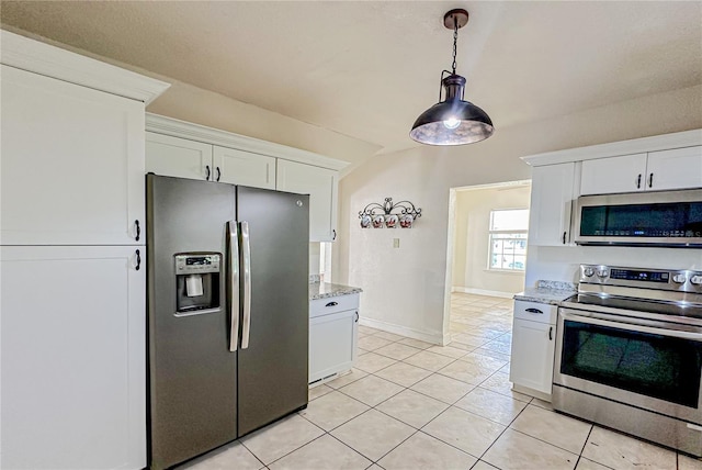 kitchen with light stone countertops, light tile patterned floors, stainless steel appliances, and white cabinetry