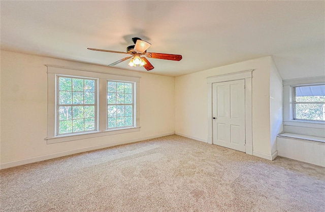 interior space featuring ceiling fan and light colored carpet