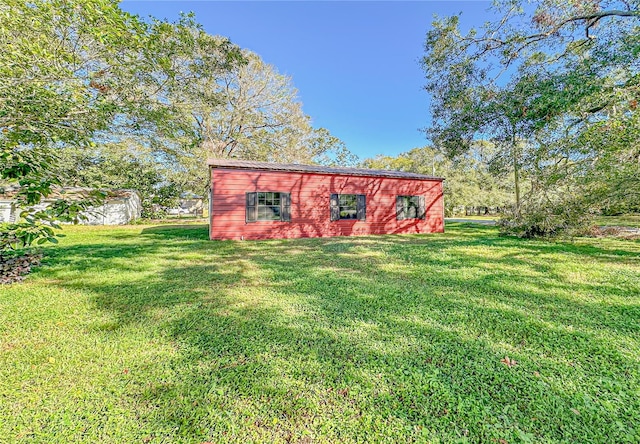 view of outbuilding with a yard