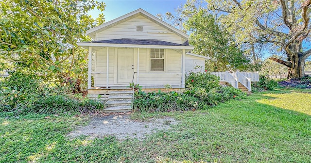 bungalow-style house with a front yard