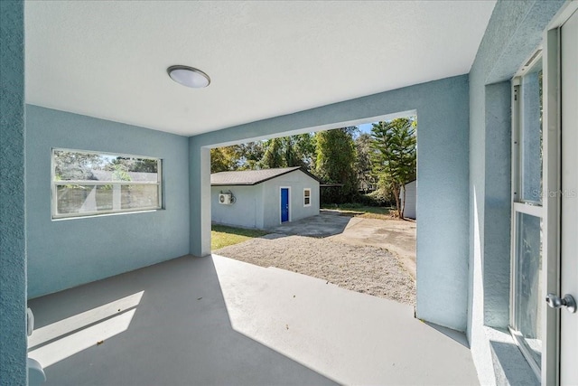 view of patio with an outbuilding