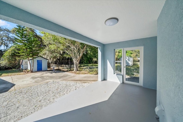 view of patio / terrace featuring a storage unit