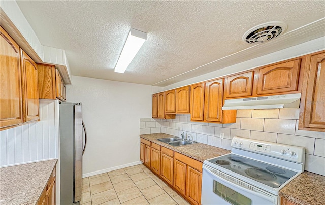 kitchen featuring sink, white electric range, backsplash, a textured ceiling, and light tile patterned floors