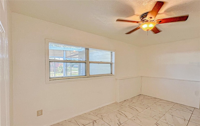 spare room with ceiling fan and a textured ceiling