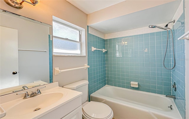 full bathroom with vanity, tiled shower / bath combo, and toilet