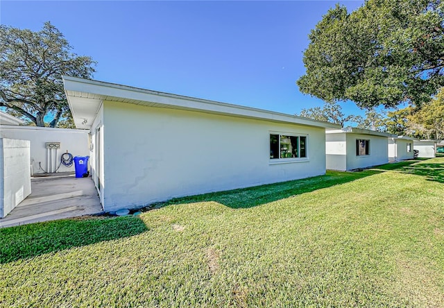 view of side of property with a yard