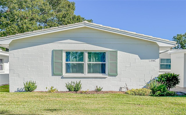 view of side of home with a lawn