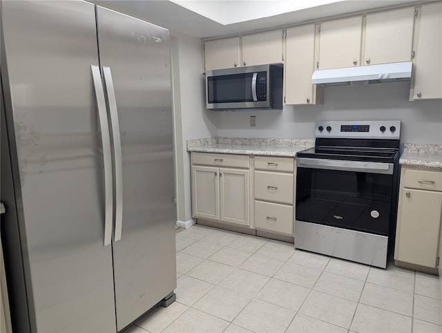 kitchen featuring light tile patterned floors and stainless steel appliances