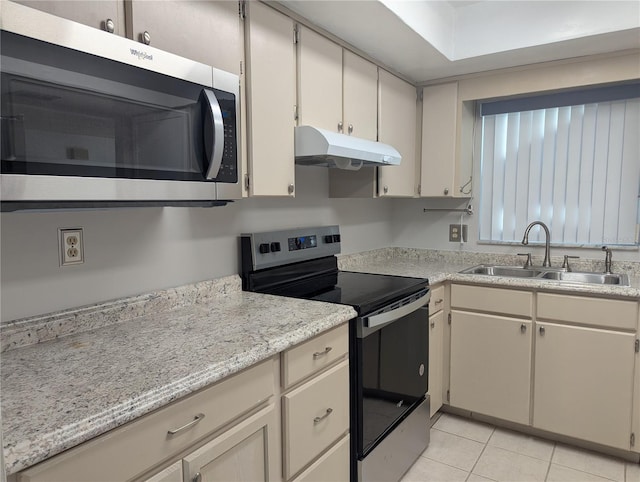 kitchen featuring light tile patterned flooring, appliances with stainless steel finishes, and sink